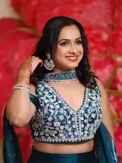 A close up of this beautiful wedding guest. The soft curls, silver jewelry, and radiant smile come together to create a look of pure elegance.