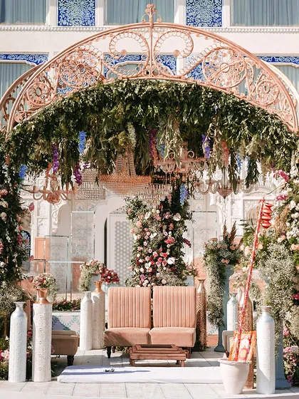 A beautifully designed seating area for a Bhaat ceremony, where every detail, from the floral arrangements to the intricate mandap, exudes charm and grace. This setup at The Leela Palace was created to be an unforgettable setting for a once-in-a-lifetime moment.