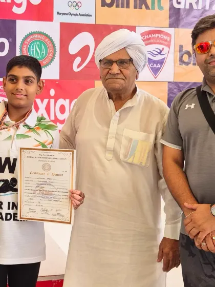 Ujjwal Yadav receiving his gold medal and certificate at the Junior Haryana State Swimming Competition. A proud moment for him and his family.