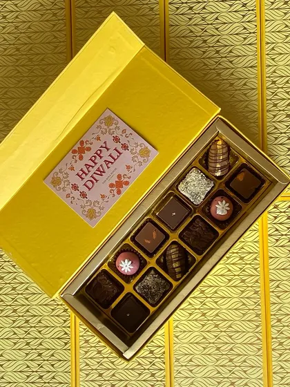 My bright yellow Fusion Treat Box, opened to reveal an assortment of handcrafted chocolates and bite-sized desserts.