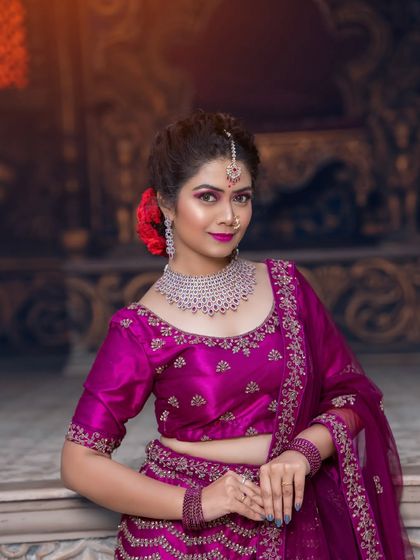 A model in a magenta lehenga, paired with a stunning diamond and ruby choker set.