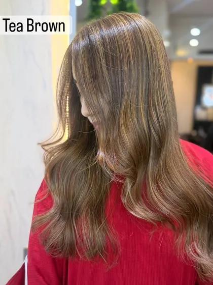 This is a perfect example of a trendy milk tea brown color. It's a soft, cool toned bronde that has been crafted to perfection, giving a softly illuminated look.
