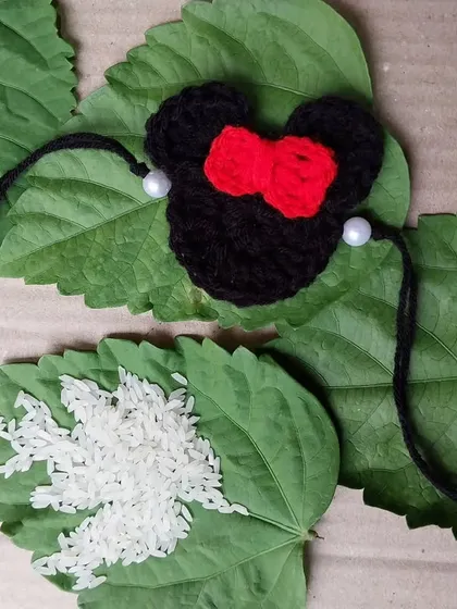 For the little ones, I make fun kids' rakhis like this Mickey Mouse design. It's a playful way for them to celebrate the festival.