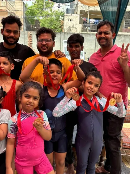 The team celebrating their success! A group photo with some of our students proudly showing off the medals they won at the competition.