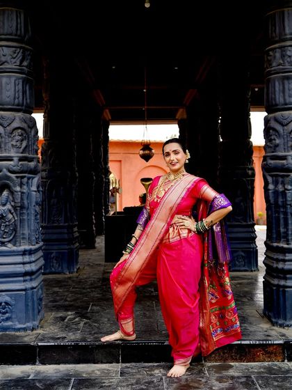A confident and powerful pose in a traditional Navari saree. This is a look that celebrates strength and heritage.