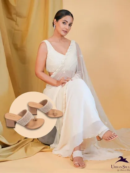 A beautiful shot of our Moti Heels, styled with a classic white saree. They offer the perfect blend of traditional charm and modern comfort.