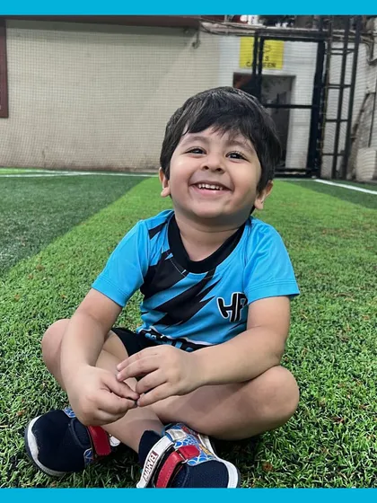 Just look at that smile! This is the result of our 'play, not push' philosophy. We create a positive and fun environment where every child feels happy, confident, and excited to be on the field.