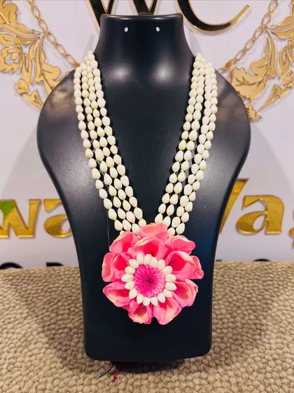 A vibrant pink floral necklace, perfect as a statement piece for a Mehendi or Sangeet function.