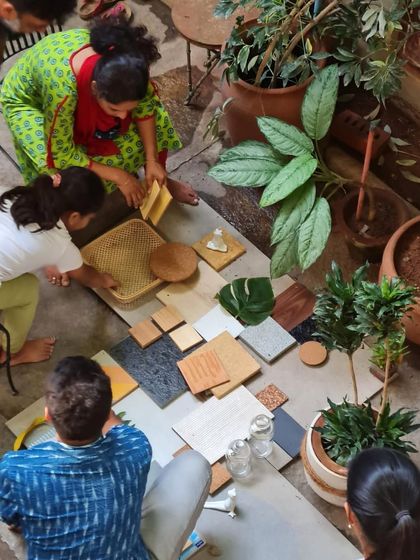 Our team and clients gather in the studio courtyard to create a material palette. This hands-on, collaborative session is a crucial part of our design process, ensuring the final home reflects the client's personal style.