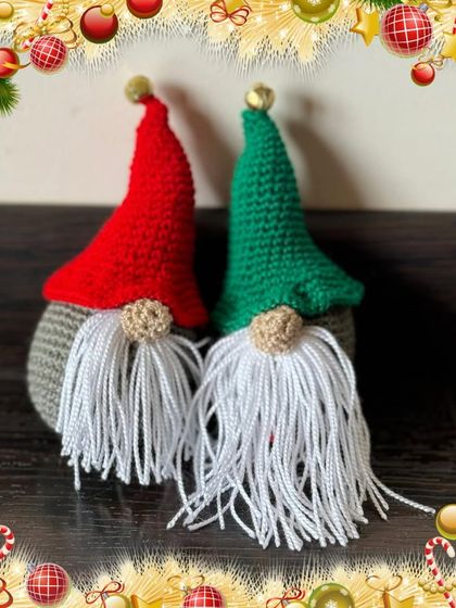 These crochet Santa gnomes are a cute and modern addition to your Christmas decor. With their long white beards and pointy hats, they add a touch of whimsy to any shelf or mantelpiece.