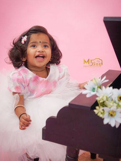 A big, joyful laugh from our little musician. This candid shot is full of energy and happiness, perfectly capturing the spirit of childhood.