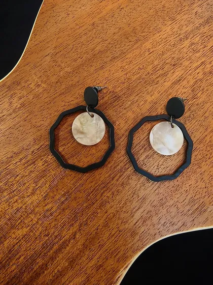 A flat-lay of the western black metal fashion drop earrings, featuring a unique geometric design.
