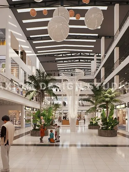 An interior render of another shopping mall concept, featuring a central atrium with a sculptural tree-like element and lush greenery.