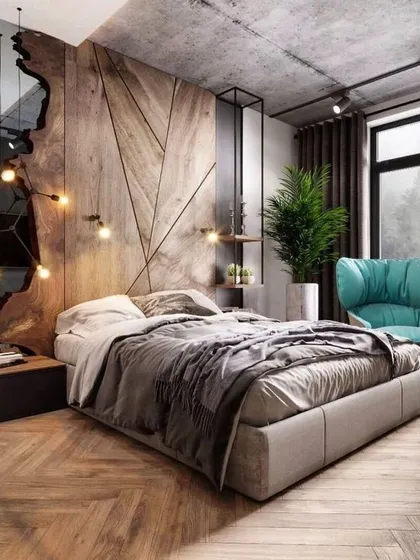 We love the dynamic energy of this bedroom design. The geometric wooden feature wall, paired with a raw-edge mirror and industrial-style lighting, creates a rustic yet contemporary space that is full of personality.