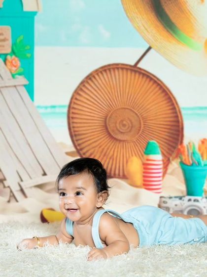 Another shot of the smiling baby on the beach set.