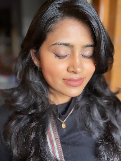 A close-up of the minimal makeup look. The skin is glowing, and the eyes are softly defined.