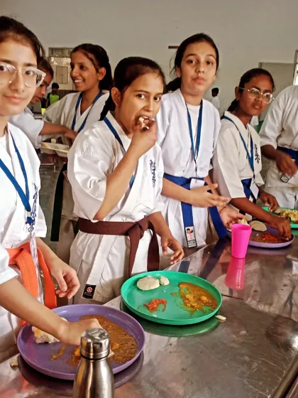 A candid shot of the students enjoying their meal together. These shared moments are what make tournament trips so memorable.