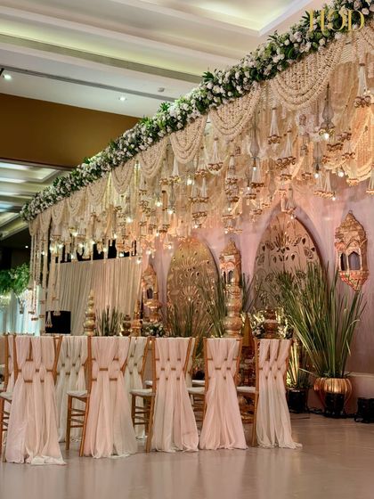A view of the guest seating in front of the stage, showing the elegant chair drapes that complement the overall luxurious theme.