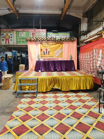 A stage and sound setup for a corporate event celebrating Labour Day. I provide the professional audio equipment needed for speeches and presentations in a formal setting.