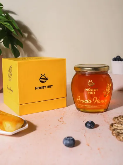 Product and packaging shot for Honey Hut's Acacia Honey. Showing the box alongside the product is important for e-commerce and retail visuals.