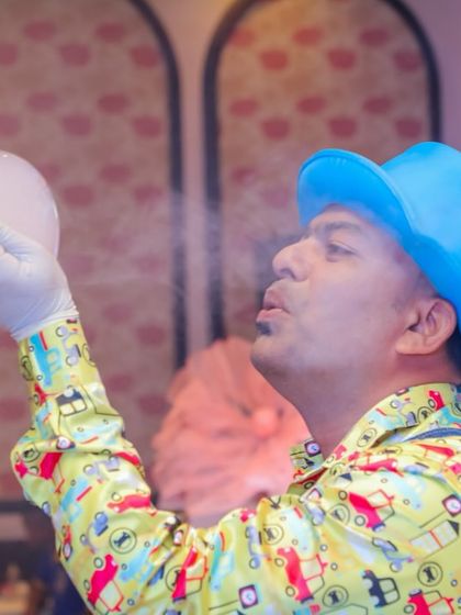 The bubble artist demonstrating how to create a bubble filled with smoke, a classic trick that always wows the crowd.