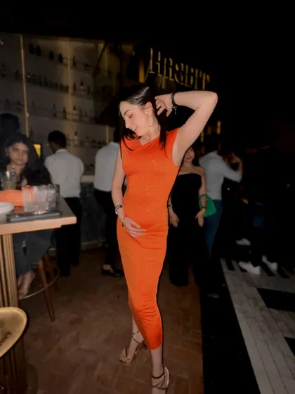 A full-length view of my orange party dress, showing how I style my outfits for a night out.
