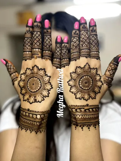 A classic sun-inspired mandala design on the palms, with detailed finger work, perfect for anyone who loves a bold centerpiece.