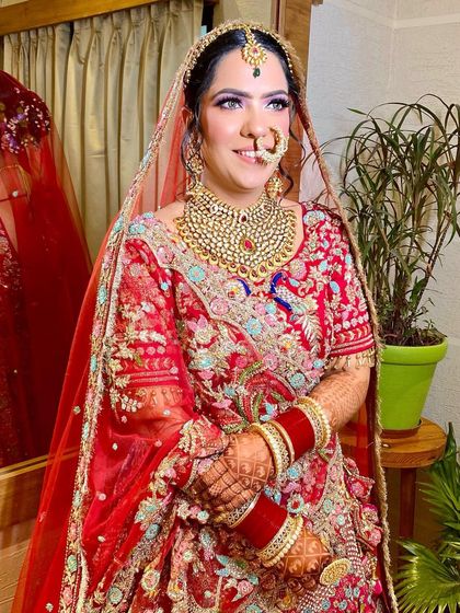 A close-up of this beautiful bride's smiling face. The makeup is soft and pretty, with a focus on rosy cheeks and a natural lip.