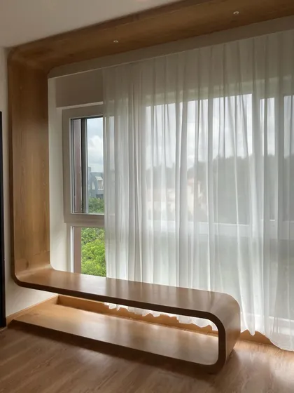 We designed this curved wooden window seat to create a serene, light-filled nook. It’s a perfect example of how we bend wood and ideas to fit a space perfectly, adding both beauty and function.