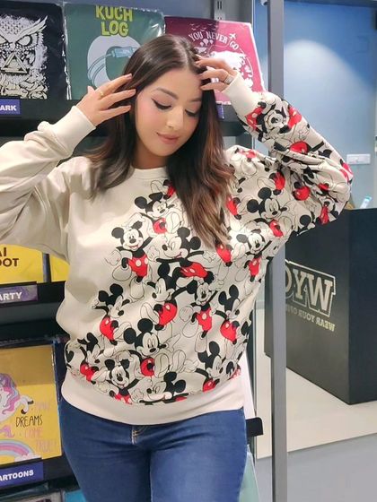This Mickey Mouse all-over print sweatshirt is a classic choice for Disney fans. It's comfortable, stylish, and perfect for a casual day out.