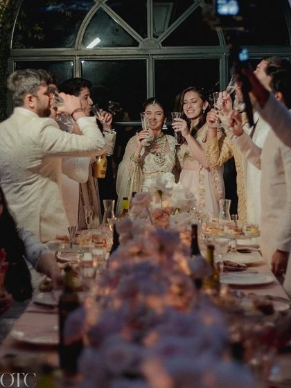 A candid shot of guests toasting at the Lake Como dinner, surrounded by the beautiful, understated decor.
