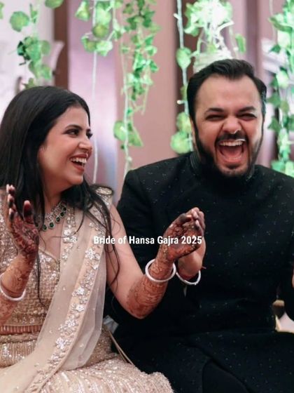 A candid shot capturing pure joy. The bride and groom's infectious laughter during their celebration is a beautiful moment of love and happiness.