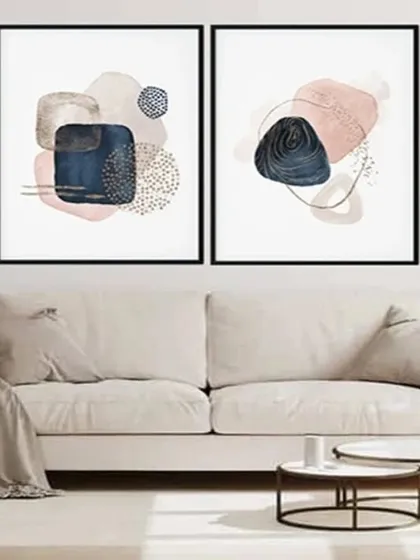 This set of two framed prints features abstract compositions of navy, pink, and neutral shapes. The modern design is perfect for creating a chic and artistic focal point in your living space.