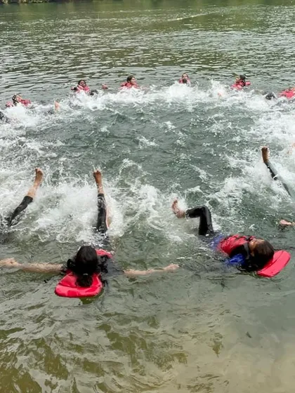 A group practices floating techniques in a circle, a fun drill that also teaches important water safety skills.
