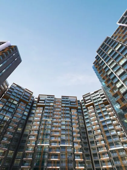 A dramatic ground-up view of Radius Avenue 54 in Mumbai, showcasing the grand scale of this luxury enclave. The design's curved facade and towering presence are meticulously planned to create a landmark of modern elegance.