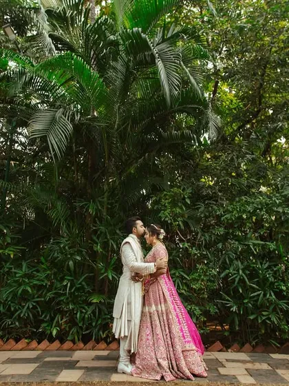 A wide shot capturing the couple in a romantic embrace, showcasing the scale of the beautiful, lush environment.