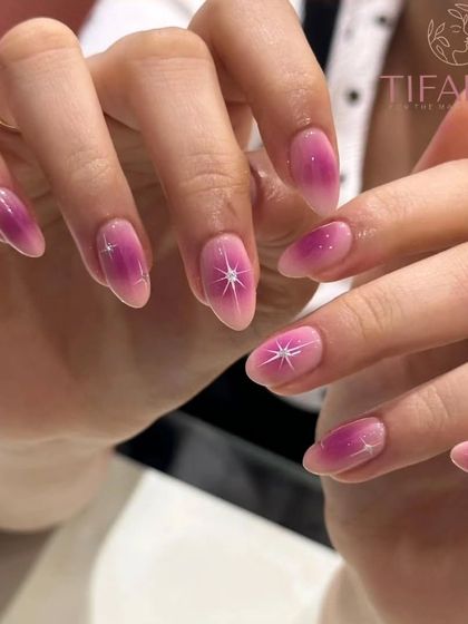 A full view of the magical gradient pink nails with sparkling star accents.
