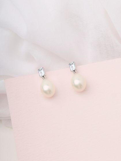 A product shot of the Blue Topaz and Pearl drop earrings, showcasing their simple, classic beauty.