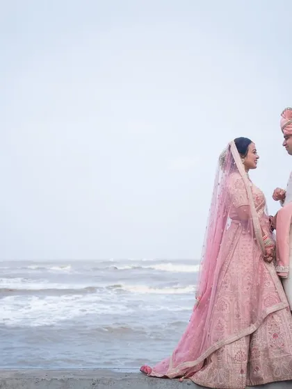 Shivani and Aniket in their stunning wedding attire, sharing a look by the sea. A pre-wedding shoot can also be a beautiful prelude in your final outfits.