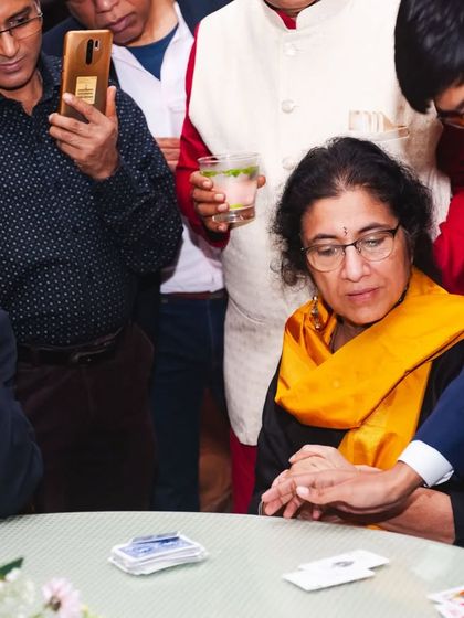 A close-up card trick where the guest is completely focused. This intimate setting allows for some of the most powerful and memorable illusions.