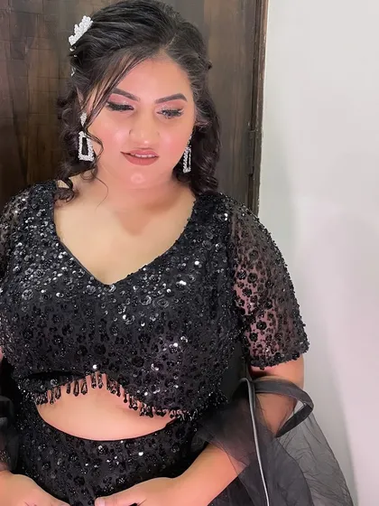A close-up of the soft glam makeup and hair. The look is sophisticated and stylish.