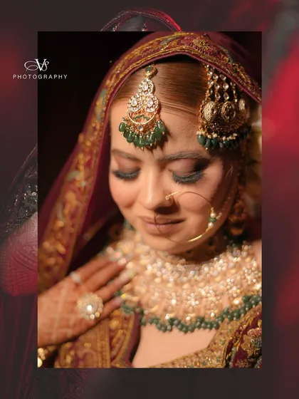 An artistic close-up of the bride, focusing on her stunning eye makeup and the intricate details of her bridal jewelry.
