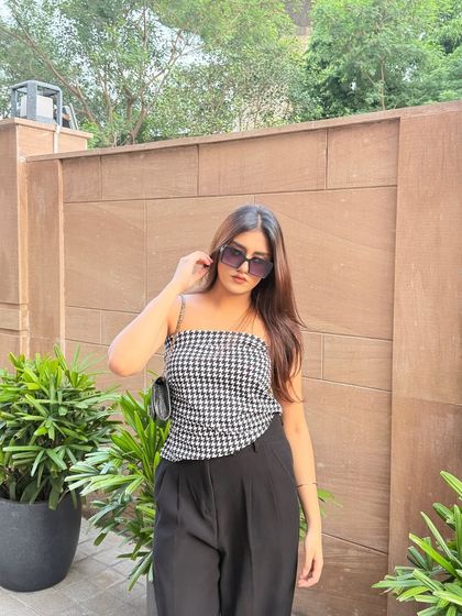 Putting on my sunglasses, ready to head out. The look is effortlessly cool.