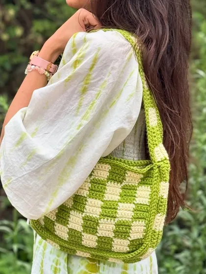 Our handmade checkered crochet shoulder bag, styled for a casual day out. This trendy and spacious bag adds a pop of color and a unique touch to any outfit.