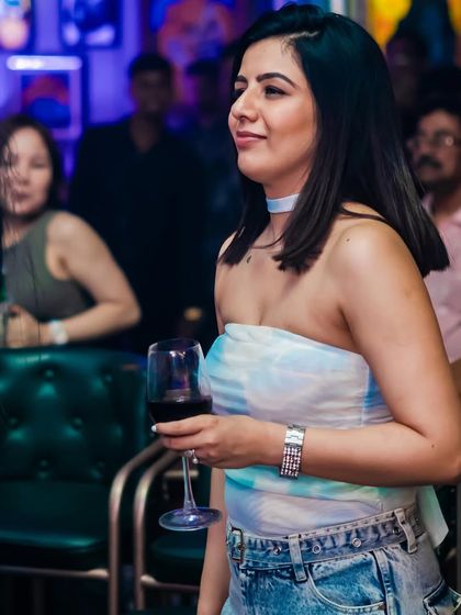 A guest enjoying a glass of wine. My events offer a complete night out experience with great drinks and music.