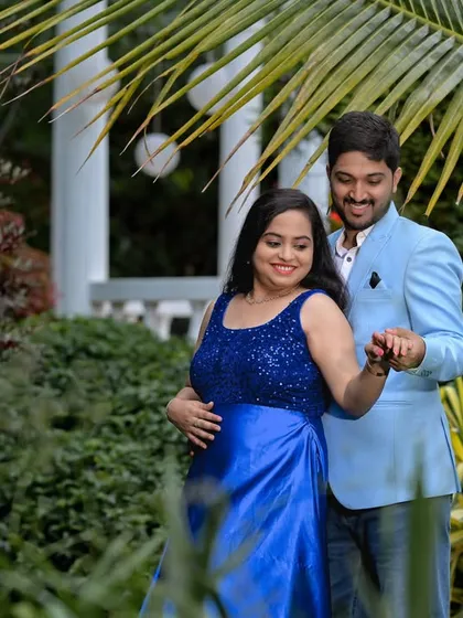 A romantic dance in the garden, framed by lush green foliage.