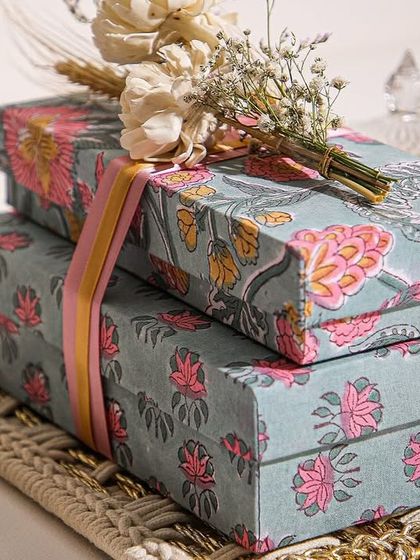 Wrapped in love, layered with sweetness. A close-up of our Rakhi Special Hamper boxes, tied with a ribbon and adorned with dried flowers.