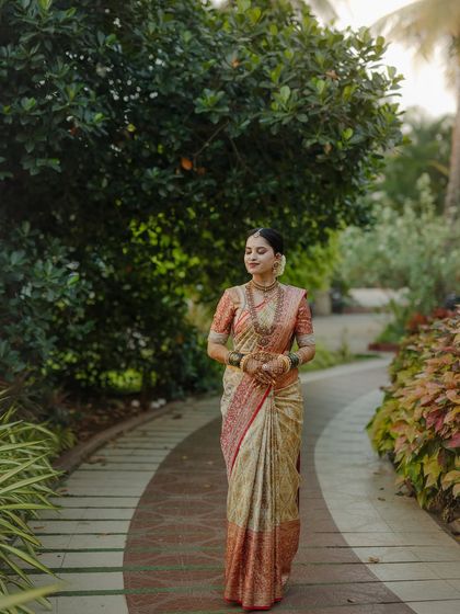 My beautiful client-turned-family, Chethana, looks timeless in this white and pink Kanchipuram saree. I designed a heavily handcrafted bridal blouse with intricate zardozi work to complement the saree's elegance for her special day.