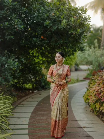My beautiful client-turned-family, Chethana, looks timeless in this white and pink Kanchipuram saree. I designed a heavily handcrafted bridal blouse with intricate zardozi work to complement the saree's elegance for her special day.