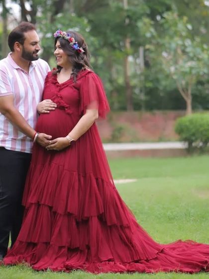 A client in a beautiful tiered maroon gown, perfect for an outdoor setting. The floral crown adds a lovely bohemian touch to the overall look.